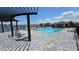 Community pool with lounge chairs and shade featuring views of the lake at 5457 Carrara Ct, St Cloud, FL 34771