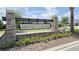 Welcome to Sunset Grove with a lovely sign and lush greenery at the community entrance at 5457 Carrara Ct, St Cloud, FL 34771