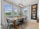 Bright dining room featuring modern light fixture, wooden table, and large windows offering scenic views at 5457 Carrara Ct, St Cloud, FL 34771