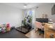 Bright home gym featuring modern exercise equipment, natural lighting and a dedicated workspace at 5457 Carrara Ct, St Cloud, FL 34771