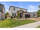 Well-manicured two-story home with a black two-car garage and green lawn at 5457 Carrara Ct, St Cloud, FL 34771