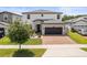 Charming two-story home with brick driveway, well-manicured lawn, and inviting front entrance at 5457 Carrara Ct, St Cloud, FL 34771