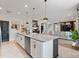 Open-concept kitchen with granite countertops, stainless steel appliances, and modern lighting at 5457 Carrara Ct, St Cloud, FL 34771