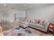 Bright living room featuring a large sofa, colorful rug, and hardwood floors at 5457 Carrara Ct, St Cloud, FL 34771