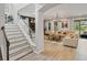 Inviting staircase leads to the open-concept living room with ample natural light and stylish decor at 5457 Carrara Ct, St Cloud, FL 34771