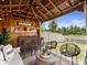 A covered outdoor bar featuring seating, overhead lighting, and access to the backyard at 5457 Carrara Ct, St Cloud, FL 34771