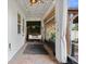 Relaxing porch featuring a swing, brick flooring, overhead lighting, and backyard views at 5457 Carrara Ct, St Cloud, FL 34771