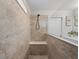 Modern bathroom featuring a tiled shower with a built-in bench and neutral color palette at 5457 Carrara Ct, St Cloud, FL 34771