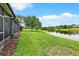 Beautiful backyard view overlooking green grass and pond creating a relaxing outdoor oasis at 6201 Goethe St # 103, Orlando, FL 32835