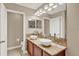 Bathroom featuring double sinks with granite countertop and a large mirror with light fixtures at 6201 Goethe St # 103, Orlando, FL 32835