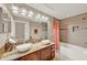 Bathroom featuring double sinks with granite countertop and a shower and bathtub combo at 6201 Goethe St # 103, Orlando, FL 32835