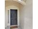 Close up of a modern front door with sidelight and arched entry at 6201 Goethe St # 103, Orlando, FL 32835
