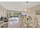 Open-concept living and dining area with lanai access and scenic backyard views at 6201 Goethe St # 103, Orlando, FL 32835