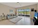Comfortable living room with sliding glass doors leading to a screened lanai and water views at 6201 Goethe St # 103, Orlando, FL 32835