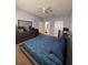 A serene bedroom featuring soft colors, a ceiling fan, and a large dresser with a mirror at 6335 Contessa Dr # 310, Orlando, FL 32829