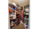 A reach-in closet featuring custom shelving filled with toys and household items at 6335 Contessa Dr # 310, Orlando, FL 32829