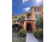 Inviting multi-story condo with well-maintained landscaping and a welcoming entrance under a bright blue sky at 6335 Contessa Dr # 310, Orlando, FL 32829