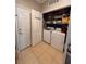 A laundry room featuring a washer, dryer, shelves, and storage space for cleaning supplies at 6335 Contessa Dr # 310, Orlando, FL 32829