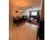 Spacious living area and dining space featuring tile flooring and a traditional chandelier at 6335 Contessa Dr # 310, Orlando, FL 32829