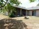 View of the backyard with patio and mature trees at 7045 Branch Ct, St Cloud, FL 34771