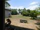 The home features a spacious backyard surrounded by mature trees, offering privacy at 7045 Branch Ct, St Cloud, FL 34771