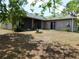 View of the backyard with patio and mature trees at 7045 Branch Ct, St Cloud, FL 34771