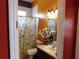 Bathroom features a floral shower curtain and vanity at 7045 Branch Ct, St Cloud, FL 34771