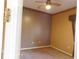 A small bedroom with tan carpet and a ceiling fan at 7045 Branch Ct, St Cloud, FL 34771