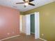 The bedroom features colorful walls, a ceiling fan, and an open closet for easy storage at 7045 Branch Ct, St Cloud, FL 34771