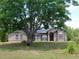 Charming single-story home with a mature tree in the front yard and stucco exterior at 7045 Branch Ct, St Cloud, FL 34771