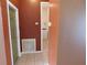 Hallway leading to a laundry room with tile floors at 7045 Branch Ct, St Cloud, FL 34771