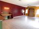 Open-concept living area with tile flooring, chandelier, desk nook, and access to other rooms at 7045 Branch Ct, St Cloud, FL 34771