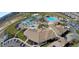 Bird's-eye view of a clubhouse and community pool area featuring water slides, seating, and lush landscaping at 725 Ocean Course Ave, Davenport, FL 33896