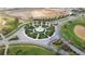Aerial view of a roundabout with a central fountain, lush landscaping, and construction in the surrounding area at 725 Ocean Course Ave, Davenport, FL 33896