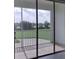 Outdoor balcony view with metal railing overlooking green golf course and blue skies at 725 Ocean Course Ave, Davenport, FL 33896