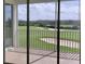 Outdoor balcony view overlooking green golf course and surrounding trees and sand traps at 725 Ocean Course Ave, Davenport, FL 33896