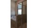 Bathroom features a soaking tub, a shower with a glass door, and tiled walls at 725 Ocean Course Ave, Davenport, FL 33896