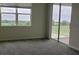 Carpeted bedroom with sliding door to the balcony offering golf course views at 725 Ocean Course Ave, Davenport, FL 33896