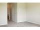 A bright bedroom features neutral carpeting, paint, and a bathroom doorway at 725 Ocean Course Ave, Davenport, FL 33896