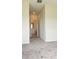 Bright bedroom features neutral carpeting, paint, bathroom doorway, and closet at 725 Ocean Course Ave, Davenport, FL 33896
