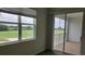 Bedroom with window view overlooking green grass golf course and balcony access at 725 Ocean Course Ave, Davenport, FL 33896