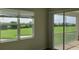 Bedroom with window and balcony overlooking green golf course on a sunny day at 725 Ocean Course Ave, Davenport, FL 33896