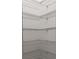 Interior view of a walk-in closet with white wire shelving for organized storage at 725 Ocean Course Ave, Davenport, FL 33896