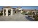 A clubhouse featuring manicured lawn, hardscape courtyard, and building features at 725 Ocean Course Ave, Davenport, FL 33896