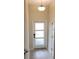 Entryway featuring a frosted-glass front door, tiled floor, and a modern light fixture at 725 Ocean Course Ave, Davenport, FL 33896