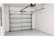 Spacious two-car garage with a white door and ample room for storage at 725 Ocean Course Ave, Davenport, FL 33896