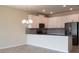 Bright kitchen with stainless steel appliances, modern lighting, gray backsplash, and breakfast bar at 725 Ocean Course Ave, Davenport, FL 33896