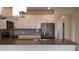 Well-lit kitchen featuring modern appliances, gray backsplash, large sink, and ample counter space at 725 Ocean Course Ave, Davenport, FL 33896