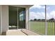 Screened-in patio with sliding glass doors offering views of a green lawn and scattered trees at 725 Ocean Course Ave, Davenport, FL 33896