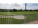 View from a screened-in patio overlooks a lush golf course with a sand trap in the distance at 725 Ocean Course Ave, Davenport, FL 33896